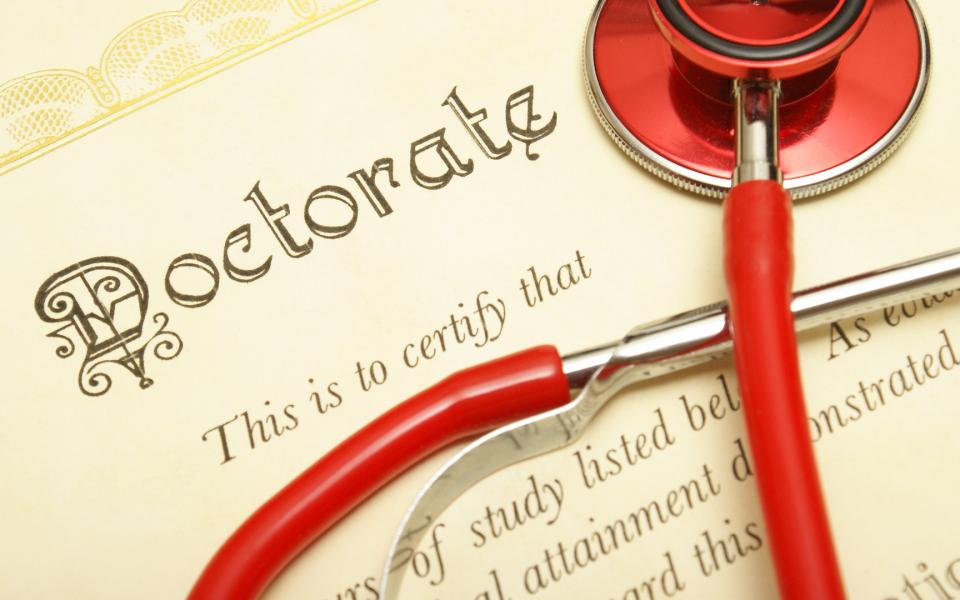 A closeup shot of a doctorate and stethoscope for the medical graduate.