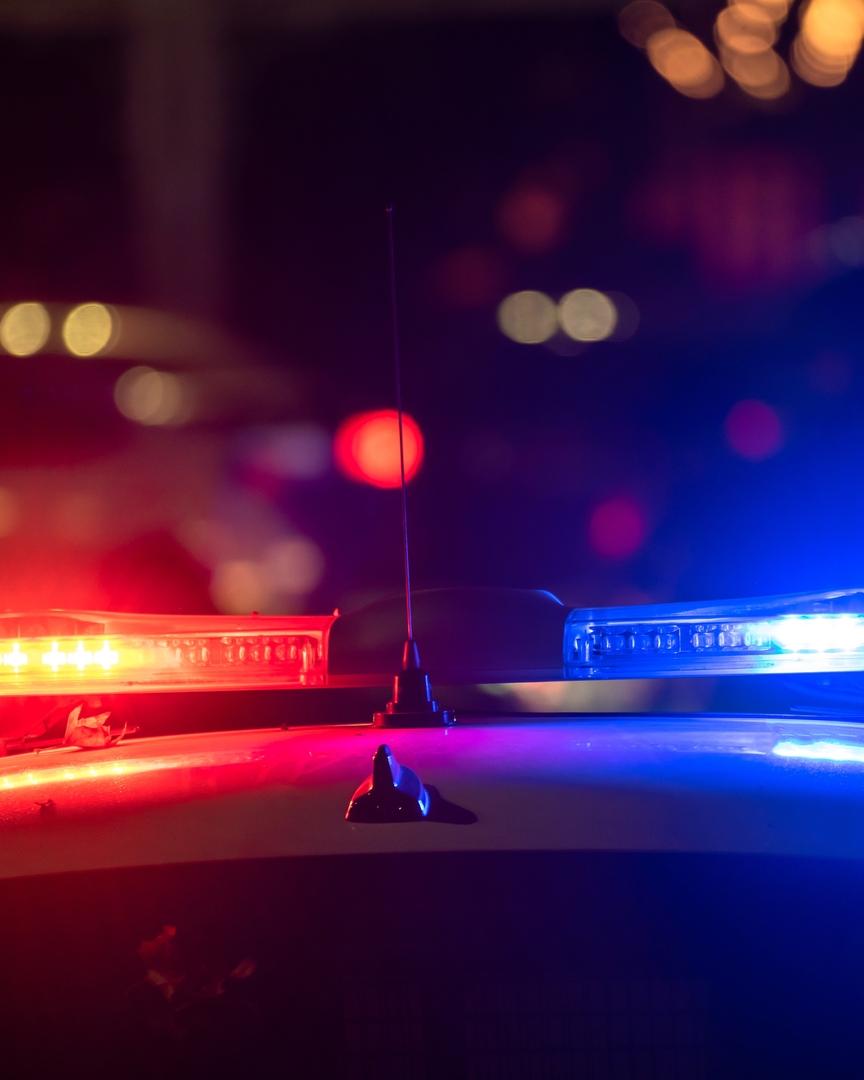 Police car with flashing lights on at night.
