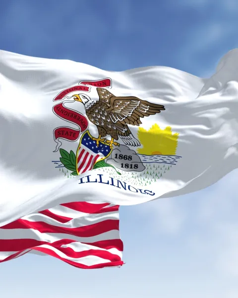 The Illinois State Flag flying in front of the American Flag.