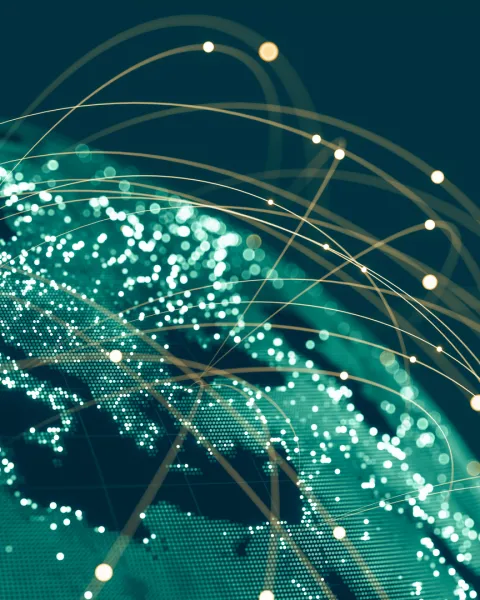 Global communications viewed from space at night with connections between cities.