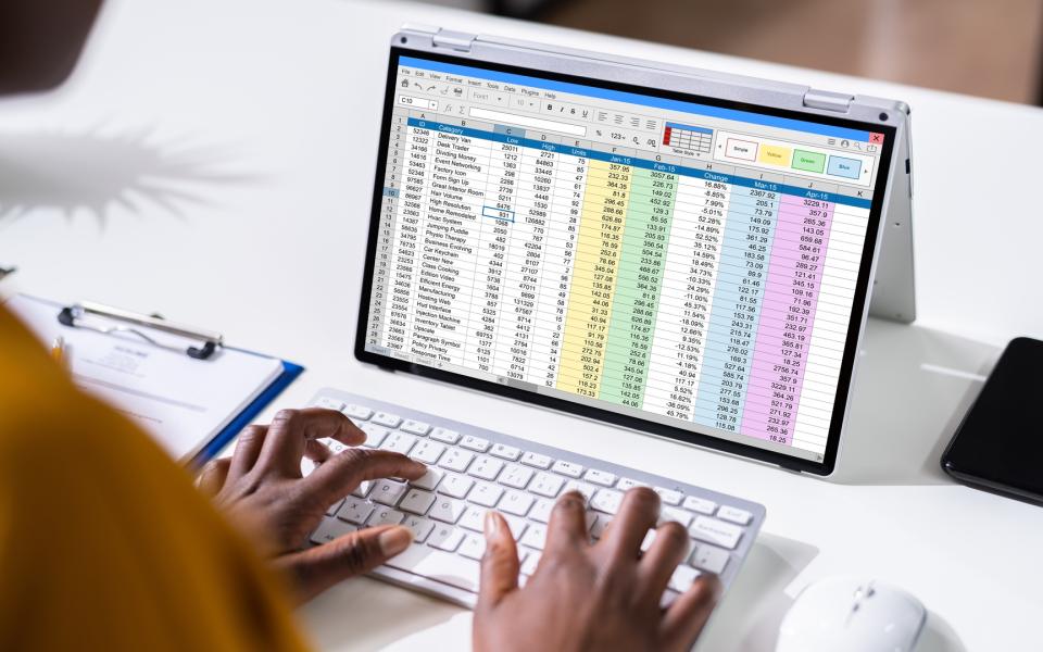 Image of a person working on an Excel spreadsheet on a tablet.