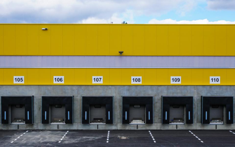 Image of the outside of a facility with multiple loading docks.