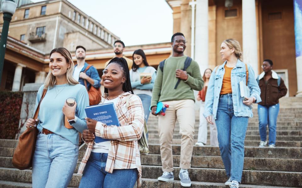 Diverse group of college students walking on campus.