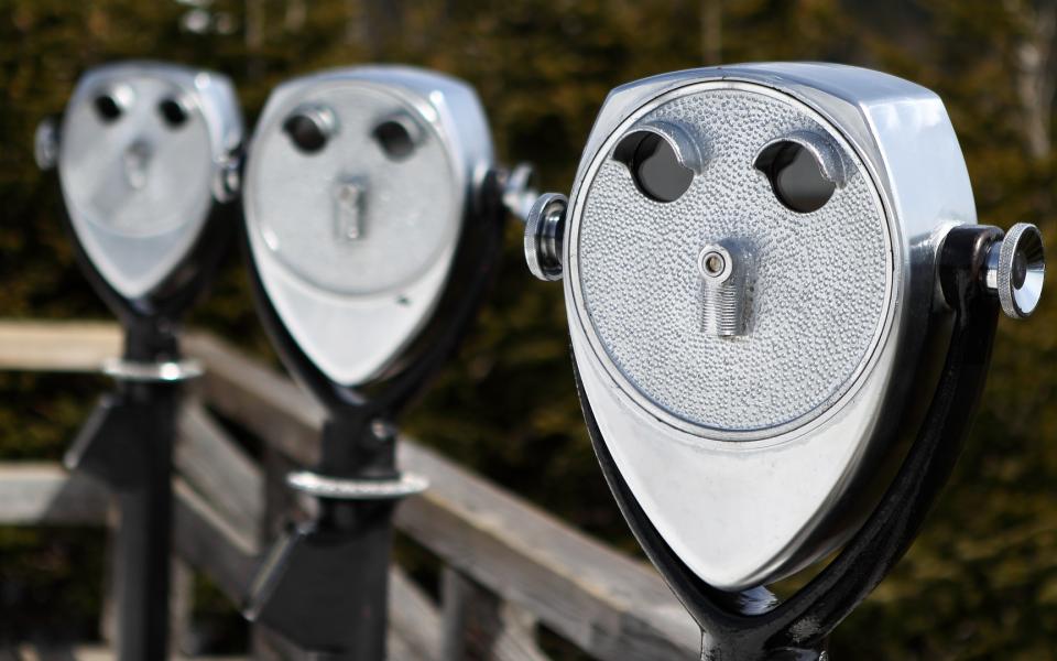 A set of three coin-operated binoculars