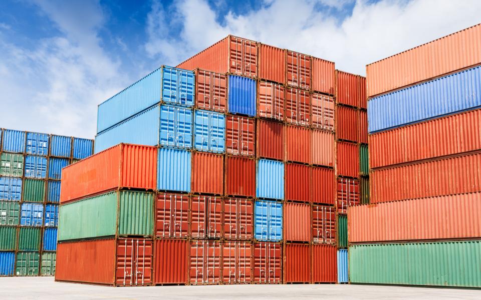 Colorful shipping containers stacked in a tiered fashion.