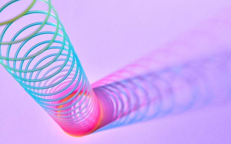 Close up of a Slinky toy, stretched up.