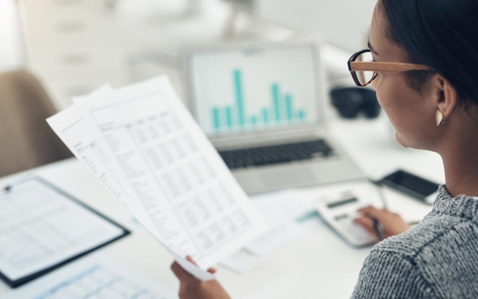 Closeup shot of a businesswoman calculating finances at her desk.