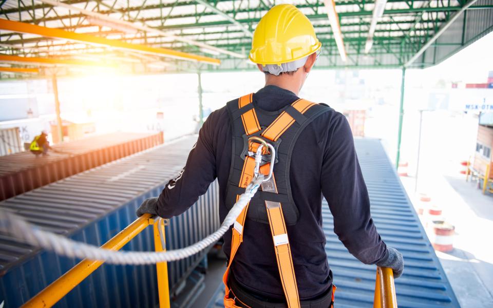 A view of a construction worker wearing a safety harness.