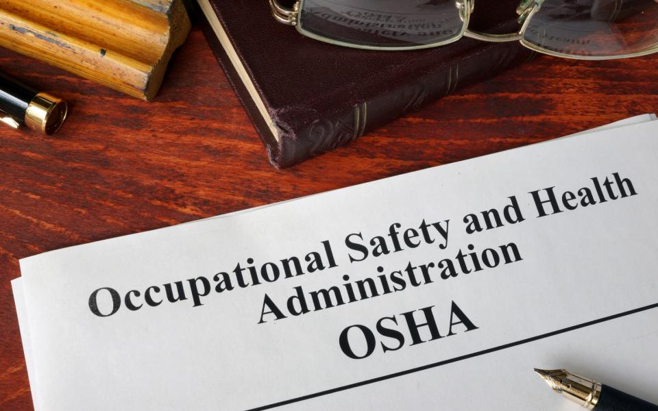 Paperwork on a desktop that reads Occupational Safety and Health Administration.