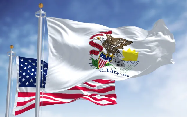 The Illinois State Flag flying in front of the American Flag.