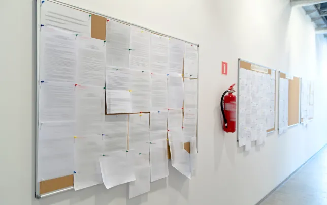 A View of a bulletin board crowded with notices.