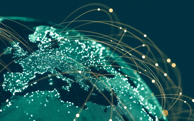 Global communications viewed from space at night with connections between cities.