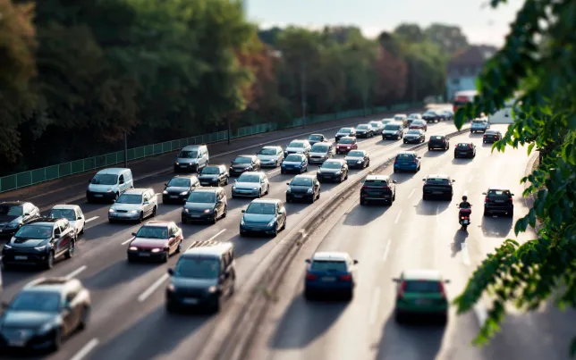 Rush hour traffic on an urban four lane road in two directions, morning commuters.