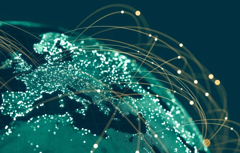 Global communications viewed from space at night with connections between cities.
