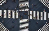 Overhead shot of a crowd walking in a crosswalk.